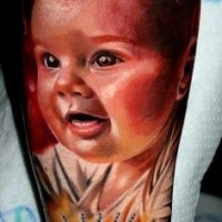 Lifelike colored portrait tattoo of little baby