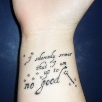 Little charming black-lettered quote tattoo on arm