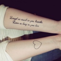 Lovely black-and-white quote and a heart tattoo on arm