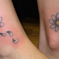 Lovely double daisy flower tattoos on feet