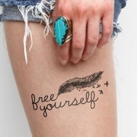 Lovely feather bird with quote tattoo on thigh
