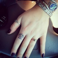 Lovely small simple lotus tattoo on finger