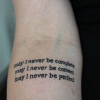 May I never be quote tattoo on arm