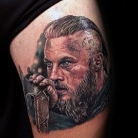 Mens Ragnar portrait tattoo on thigh