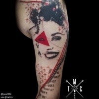 Modern abstract style upper arm tattoo of smiling woman with red triangle