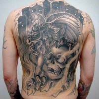 Modern style black ink whole back tattoo of gargoyle combined with human skull in fron of night city
