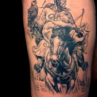 Mongolian warrior on horseback with a bird tattoo on thigh