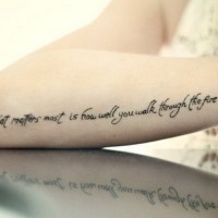 Nice capital-letter quote with hippie sign tattoo on arm