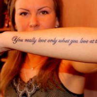 Nice elegant black-lettered quote tattoo on arm