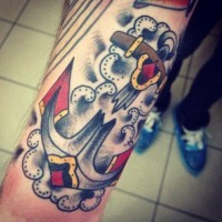 Old school anchor in clouds tattoo on forearm