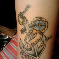 Old school flowered anchor with Odessa lettering tattoo on forearm