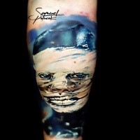 Old school style colored upper arm tattoo of monster portrait