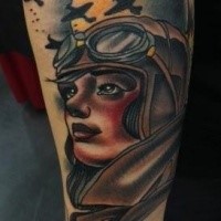 Old school style colroed forearm tattoo of woman pilot combined with planes and moon