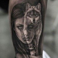 Portrait of girl with wolf tattoo on arm