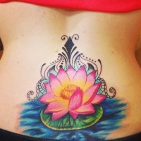 Pretty lotus flower on water with curls tattoo on lower back