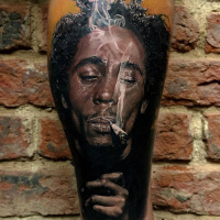 Realistic Bob Marley portrait tattoo