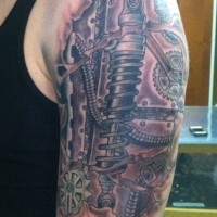Tatuaje  de mecanismos gruesos en el brazo