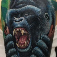 Realistic furious black gorilla tattoo on arm