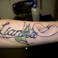 Romantic girlfriend name quote with lily tattoo on arm
