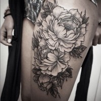Rough-sided black-and-white flower tattoo on thigh
