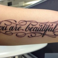 Rousing you are beautiful quote tattoo on arm