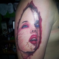 Scare red-colored lady vampire tattoo for men on upper arm