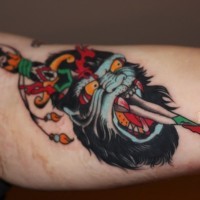 Scary old school color-ink gorilla head pierced by knife tattoo on upper arm