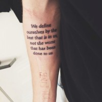 Simple printed text quote tattoo on arm