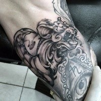 Sketch style black ink gargoyle statue tattoo on biceps