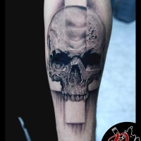 Skull and cross tattoo on forearm