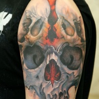 Skull collage tattoo on shoulder for men