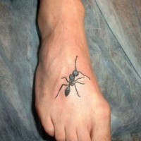 Small black-and-white ant tattoo on foot