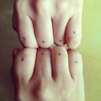 Small lettered love and hate quotes tattoo on finger