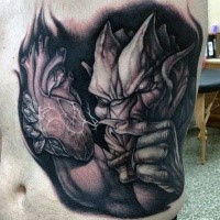 Superiror 3D like detailed belly tattoo of gargoyle with human heart