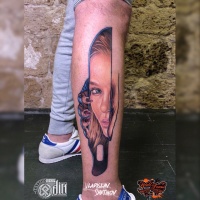 Tattoo with girl face reflection on knife
