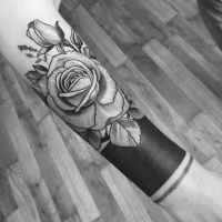 Tattoo with roses on forearm