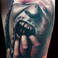 Terrifying horror style colored upper arm tattoo of zombie woman