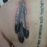 Three large white eagle feathers tattoo on back