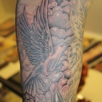 Traditional black-and-white dove with rose tattoo on upper arm