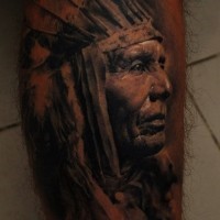 Tribe leader in profile tattoo on shin