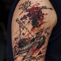 Typical trash polka style upper arm tattoo of old plane with lettering