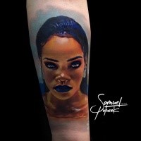 Unique looking colored tattoo of Rihanna portrait