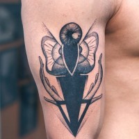 Unusual abstracl moth tattoo for men on upper arm