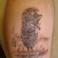 Unusual black-and-white hedgehog with white bag tattoo on leg