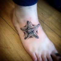 Unusual black-and-white starfish tattoo on foot