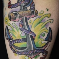 Unusual color-ink anchor in green splashes tattoo on shin