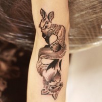 Unusual reflected black-and-white hare and fox tattoo on arm