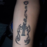 Unusual tribal black-ink guitar tattoo on forearm