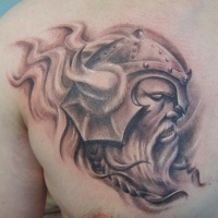Vicious Viking in horned helmet tattoo on shoulder