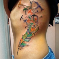 Vivid-colored feather bird tattoo on rib-side